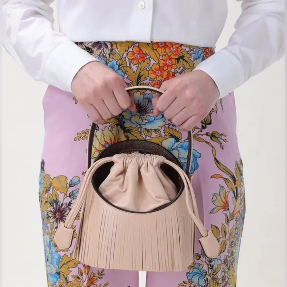 Etro Saturno Runway fringed leather bucket bag in a light pink/beige color